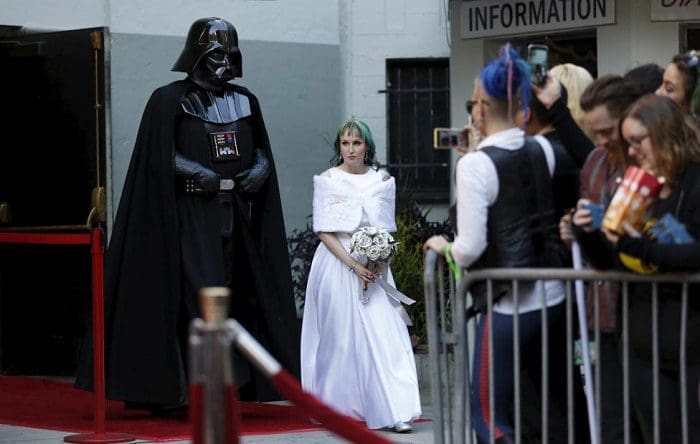 Caroline Ritter from Australia arrives for her wedding ceremony escorted by a person dressed as the character of Darth Vader from Star Wars December 17, 2015. REUTERS/Mario Anzuoni