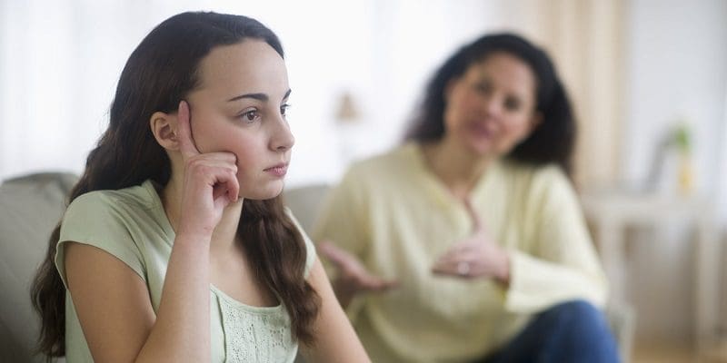 USA, New Jersey, Jersey City, Mother with teenage girl (14-15) sitting on sofa