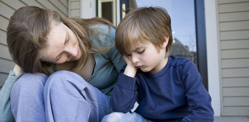 MOTHER AND SON SITTING ON PORCH