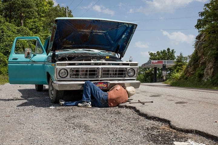 hombre debajo de un auto 